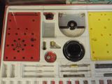a box with a clock and various tools inside of it