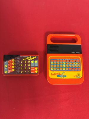 a small calculator and a remote on a red surface