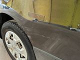 a close up of a car ' s front bumper and tire