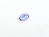 a close up of a blue sapphire stone on a white surface