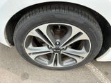 a close up of a tire on a white car