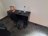 a desk with a chair and a bottle of water on top of it