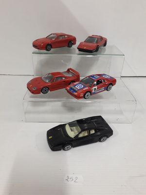 three toy cars are on display in a glass case