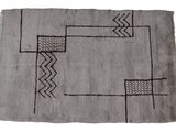 an old rug with a black and white design on it