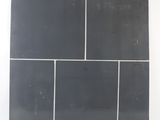 an image of a piece of black tile on a white wall