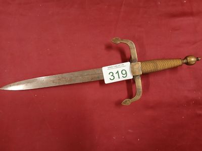 a close up of a sword on a red surface