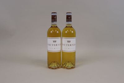 two bottles of white wine sitting next to each other on a table