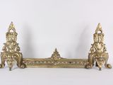 a gold metal shelf with a clock on top of it