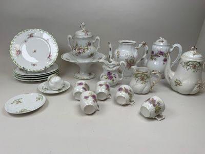 many different types of porcelain dishes and cups on the table