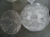 a glass plate and a glass bowl sitting on a table