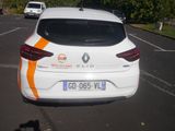 a white car with an orange stripe parked in a parking lot