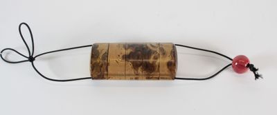 wooden bead with a red bead on a string