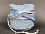 a blue bag with a blue ribbon wrapped around it