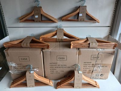 several boxes of clothes hangers are stacked on top of each other