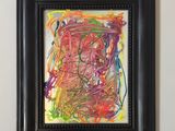 abstract painting in a black frame hanging on a wall