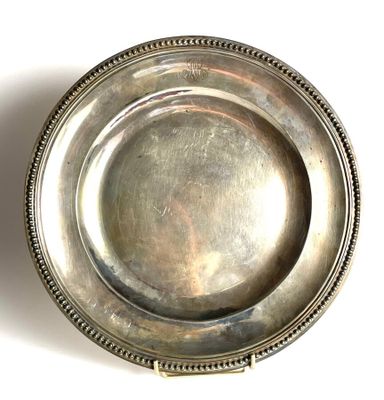 a silver plate with a beaded edge on a white surface