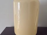 a cream colored container sitting on a black table