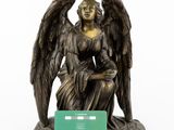 statue of an angel with a green card on a white background