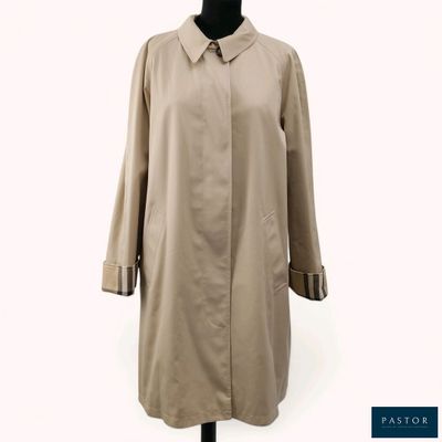 an image of a woman ' s coat on a mannequin stand