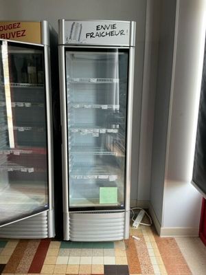two refrigerators that are sitting in the corner of a room