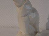 a white elephant statue sitting on a white surface
