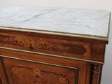 a marble top on the top of a wooden cabinet