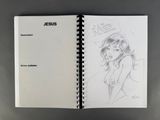 an open sketch book with a drawing of a woman on it