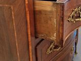 a wooden desk with a marble top and a drawer