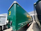 two semi trucks parked next to each other in a parking lot