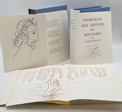 two open books with drawings on them on a table
