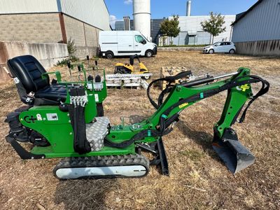 an image of a small green excavating machine
