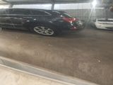 a reflection of a car in a window of a building