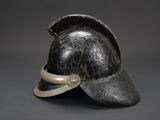 an old helmet with a metal band around the brim of the brim