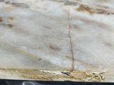 a close up of a marble table top on a tiled floor
