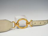 a white belt with a gold ring on it