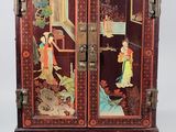 a wooden cabinet with a painting on it