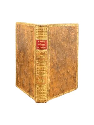 an old book that is sitting on a white surface