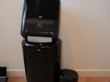 a black trash can sitting next to a black trash can