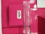 a ruler that is on top of a pink box