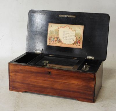 a wooden box that has a music box inside of it