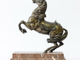 bronze statue of a horse on a marble base on a white background