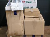 des cartons empilés sur des palettes devant un mur sur lequel est accrochée une pancarte