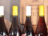 several bottles of wine are lined up on a table