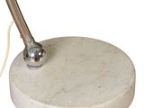 a white marble table with a metal pen on it