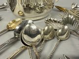 many silver spoons and spoon spoons on the table