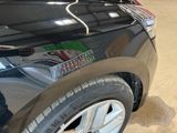 a close up of a black car with a sticker on it