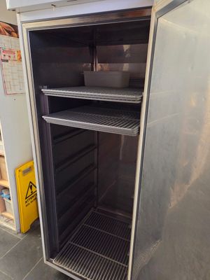 an open refrigerator in the middle of a kitchen