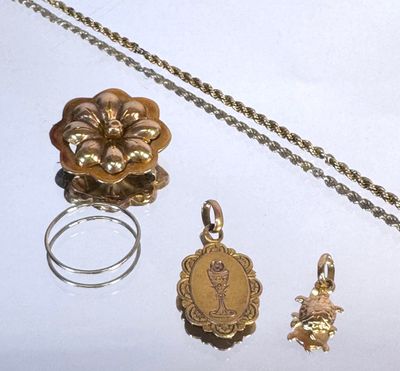 un collier en or, une bague et d'autres bijoux posés sur une table