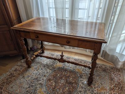 a wooden table with a drawer on top of it