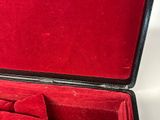 a red case with a bow tie inside of it